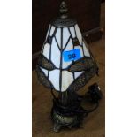 A small Tiffany style table lamp