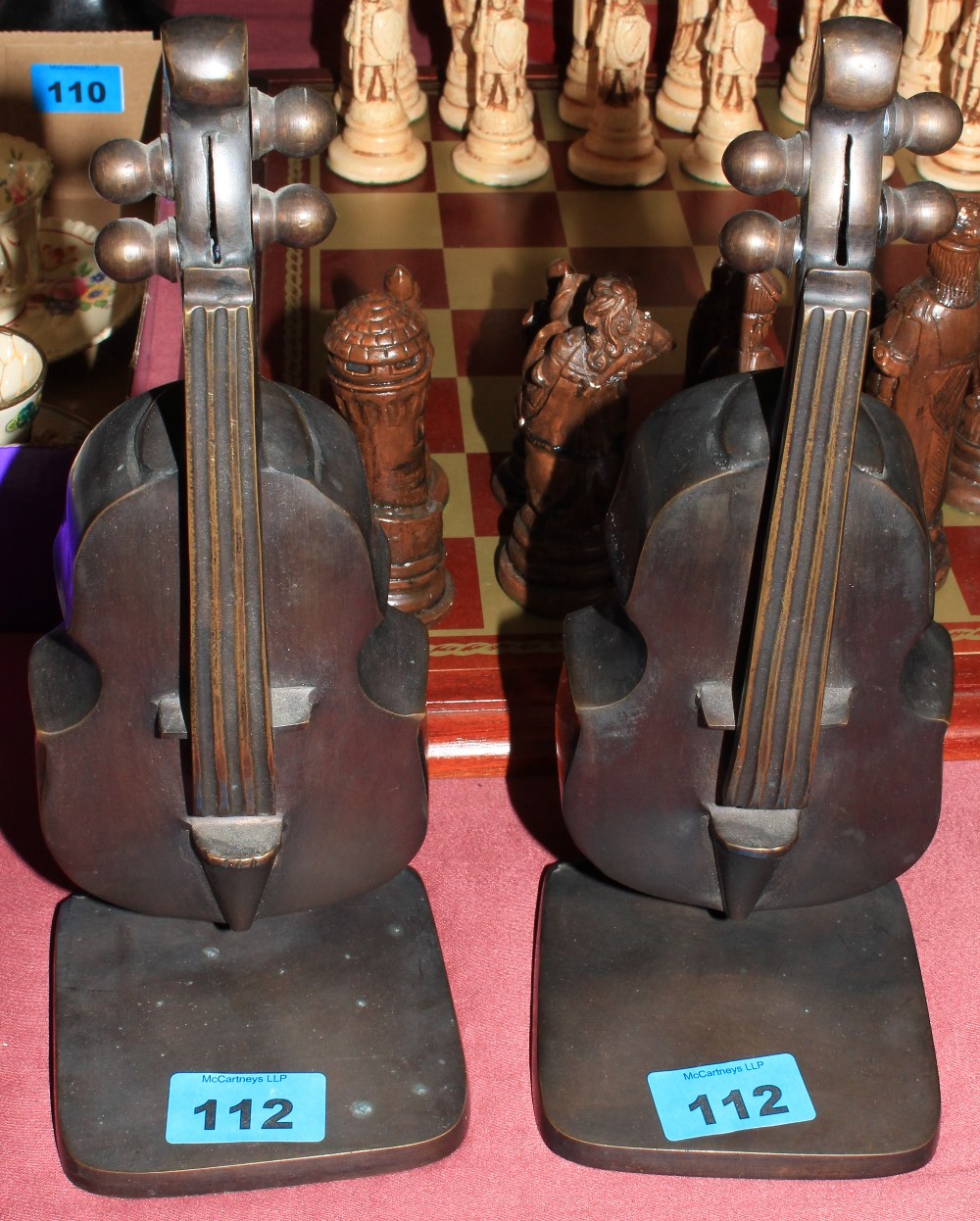 A pair of bronze double bass bookends
