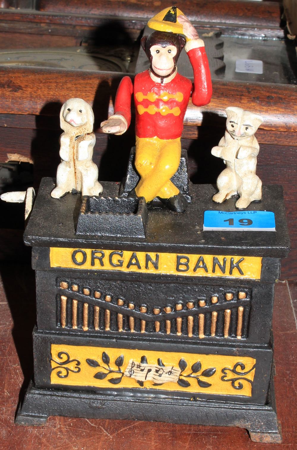 An iron novelty monkey organ moneybox