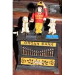 An iron novelty monkey organ moneybox