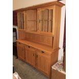 A light oak finished dresser with Art-Nouveau style decoration. 64" wide