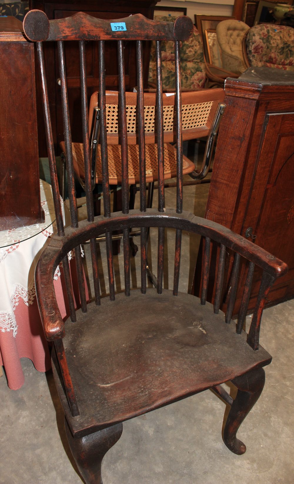 An antique comb back Windsor chair on cabriole legs