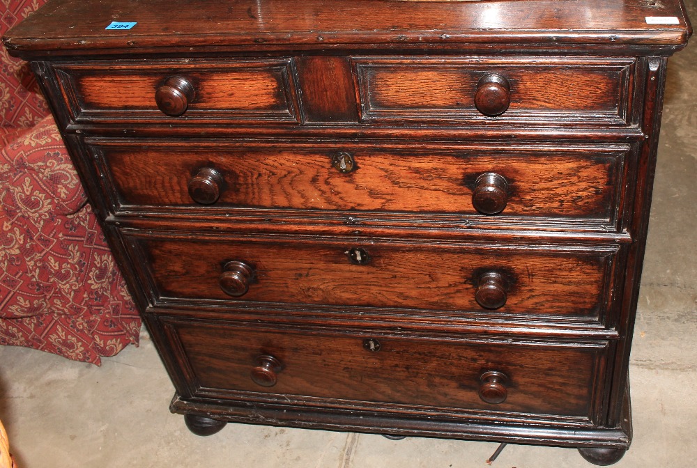 An 18th Century oak chest with two short over three long fielded moulded drawers on bun feet. 36"