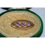 A 9ct three stone amethyst brooch and a plated fob seal