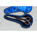 A Victorian silver pair of grape scissors, the twisted shafts with bright cut foliage and
