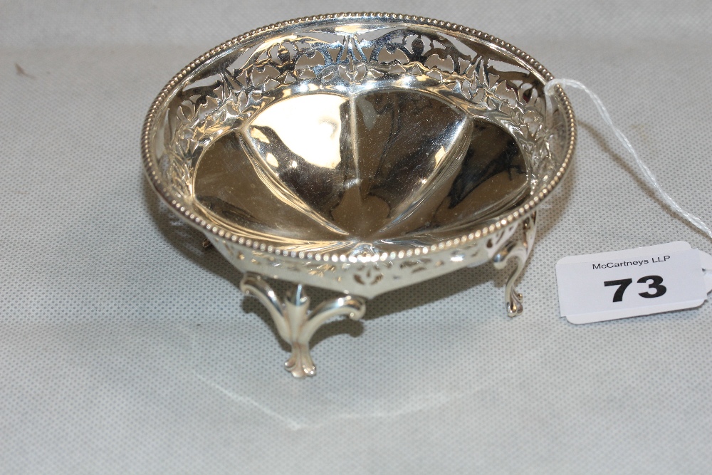 73. A silver bonbon bowl with beaded rim and pierced border. 4 ¼" diam. Birmingham 1923