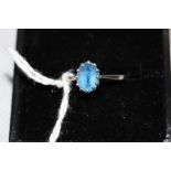 An 18ct white gold aquamarine single stone ring, mounted in a 12 claw setting with an oval 8x6