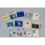 Twenty silver charms in a brass state Express cigarette box