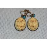 A pair of foliate carved bone earrings, the 9ct screw clips with turquoise stone