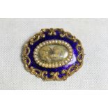Mourning jewellery. A gold, blue enamel and split pearl brooch, the centre with a lock of hair,