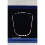 A Swarovski rhodium plated necklace set with baguette white stones