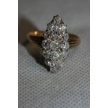 A diamond cluster ring with seventeen stones, the centre stone 0.25ct, in a navette setting. In