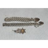 Two silver locket link bracelets and a silver filigree flower brooch