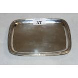 A George III silver oblong dish with reeded rim and inset mahogany base. 7" wide. London 1808