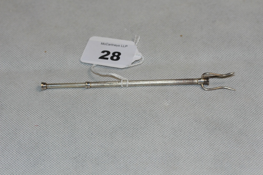 A silver pickle fork with engine turned decoration. Birmingham 1961