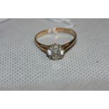 A white stone solitaire ring. In gold marked 375. Size L