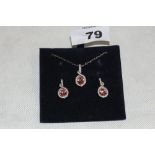 A Swarovski pink and white stone suite of pendant and earrings