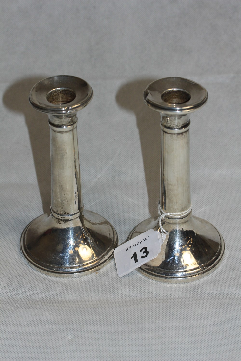 A pair of George V silver loaded candlesticks of plain form. 5 ½" high. Birmingham 1920 (Dents,