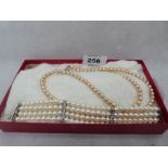 An imitation pearl necklace and bracelet