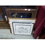 A carved wood frame and two prints