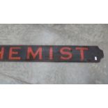 A large painted wood 'Chemist' sign