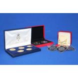 SIX CASED SETS OF COINS
including silver gilt examples,