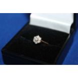 DIAMOND CLUSTER RING
marked eighteen carat, seven stones totalling approximately 0.