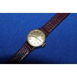LADY'S 9CT GOLD TISSOT WRIST WATCH
on a maroon leather strap