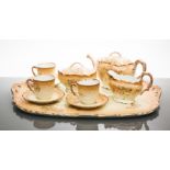 EARLY 20TH CENTURY LIMOGES TEA SERVICE
comprising three teacups and saucers, teapot, sugar,