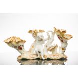 MOORE BROTHERS TRIPLE FLOWER TRUMPET VASE
with blanc de chine cherub centre,