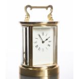 TWENTIETH CENTURY ENGLISH BRASS CARRIAGE CLOCK
by ACG, of circular form,