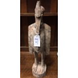 IVORY COAST CARVED WOOD FIGURE OF A BIRD
with spiked crest,