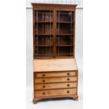 COMPOSED WALNUT BUREAU BOOKCASE OF GEORGE III DESIGN 
the moulded dentil cornice with adjustable