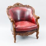 OXBLOOD LEATHER AND CARVED MAHOGANY SUITE
comprising a three-seater settee and two armchairs,