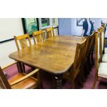 VICTORIAN OAK EXTENDING DINING TABLE
with one additional leaf, on turned tapering legs,