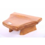 WORKSHOP OF TIM STEAD STOOL elm hearth stool with dished seat, on shaped feet,