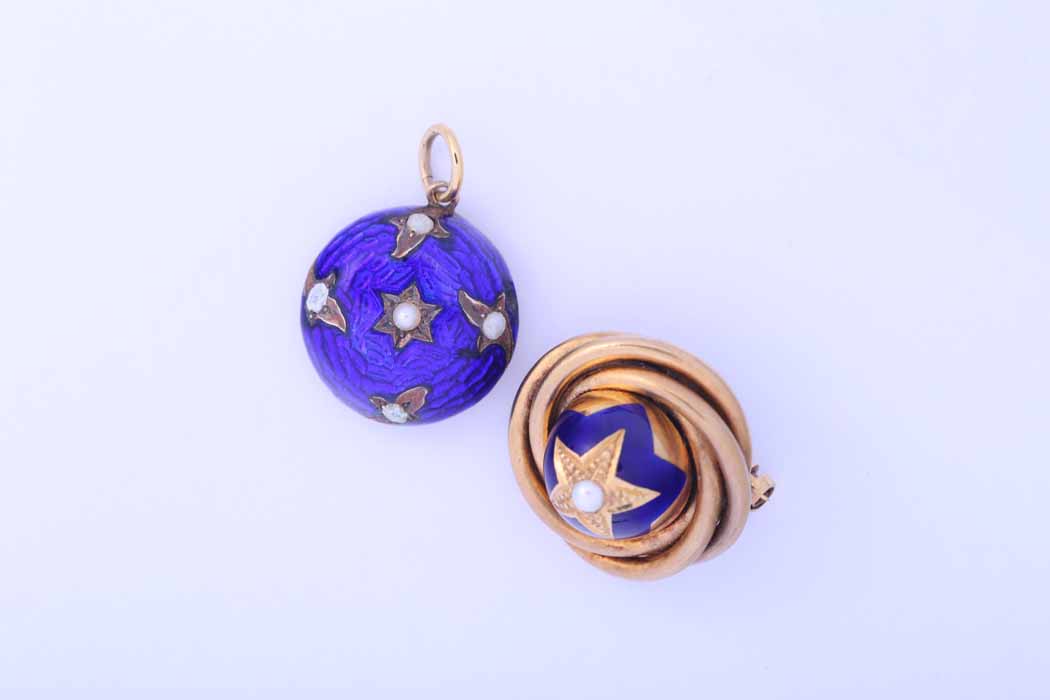 TWO VICTORIAN ENAMEL AND SEED PEARL PENDANTS both of circular form, both with royal blue enamel,