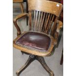 CAPTAIN'S STYLE CHAIR with leather seat and on a revolving base with casters