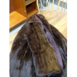 TWO LADY'S FUR COATS including a brown Russian Squirrel 3/4 length coat and a dark brown sheep skin
