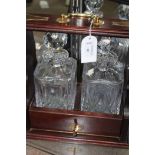 BRASS MOUNTED TWO DECANTER TANTALUS with crystal decanters,