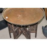 INDIAN BRASS CIRCULAR FOLDING TABLE together with a copper circular top