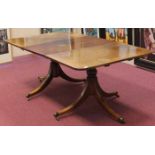 REGENCY MAHOGANY TWIN PEDESTAL DINING TABLE on baluster turned pillars with tripod scroll legs,