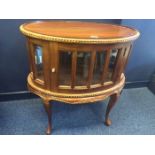 MAHOGANY OVAL CURIO CABINET OF 18TH CENTURY DESIGN inset with bevelled glass panels,