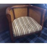 VICTORIAN WALNUT FRAMED BERGERE-STYLE TUB CHAIR over fluted, turned forelegs, approximately 72.