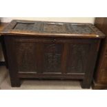 17TH CENTURY CARVED OAK BLANKET CHEST the hinged cover with three indented panels,