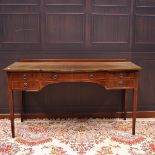 EDWARDIAN MAHOGANY SHERATON REVIVAL DRESSING TABLE with central bowed frieze drawer,