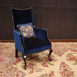 EDWARDIAN UPHOLSTERED ARMCHAIR with concave shaped back, upholstered in blue studded dralon,