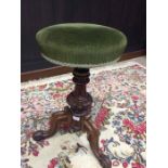 VICTORIAN MAHOGANY AND ROSEWOOD ADJUSTABLE PIANO STOOL the circular seat upholstered in olive green