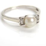 ATTRACTIVE PEARL AND DIAMOND RING the bezel of an art deco design,