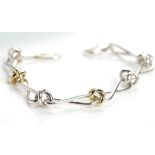 TIFFANY PALOMA PICASSO BRACELET with crossed links, in eighteen carat gold and silver, 19cm long,